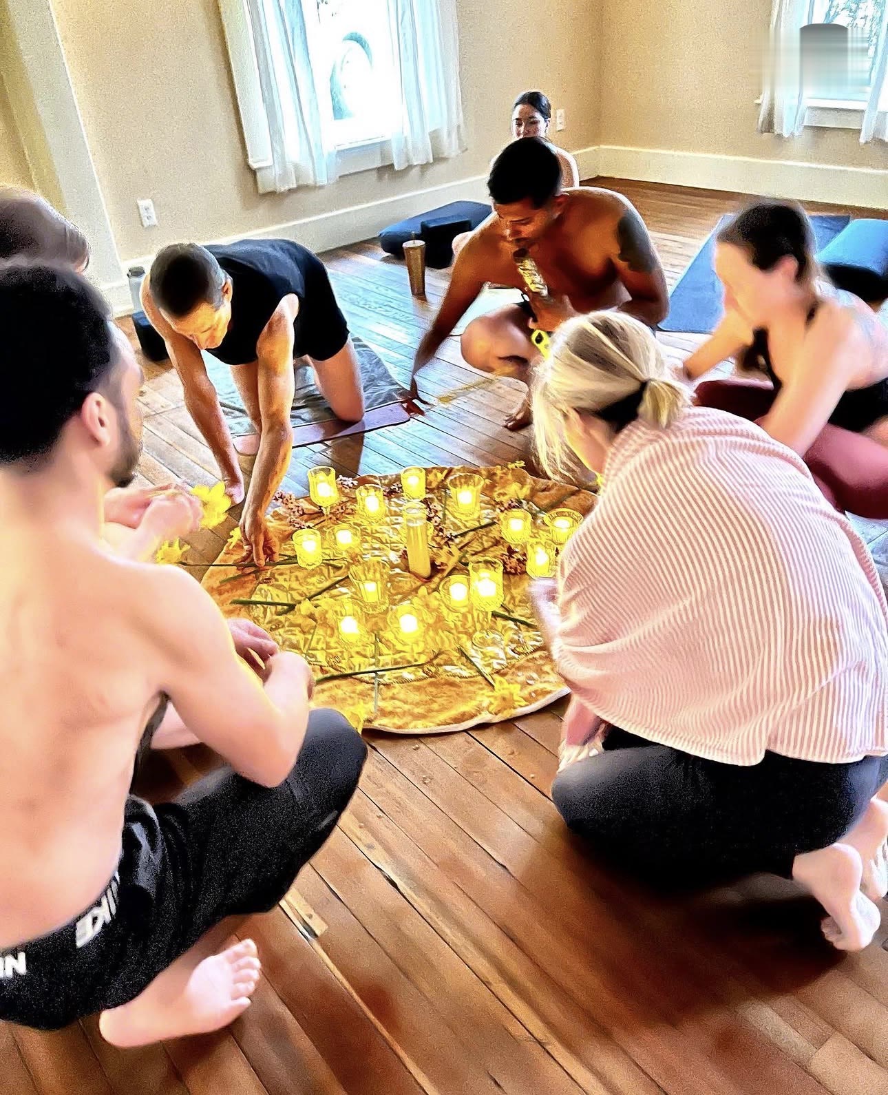 Students arranging candles and flowers at a workshop ceremony