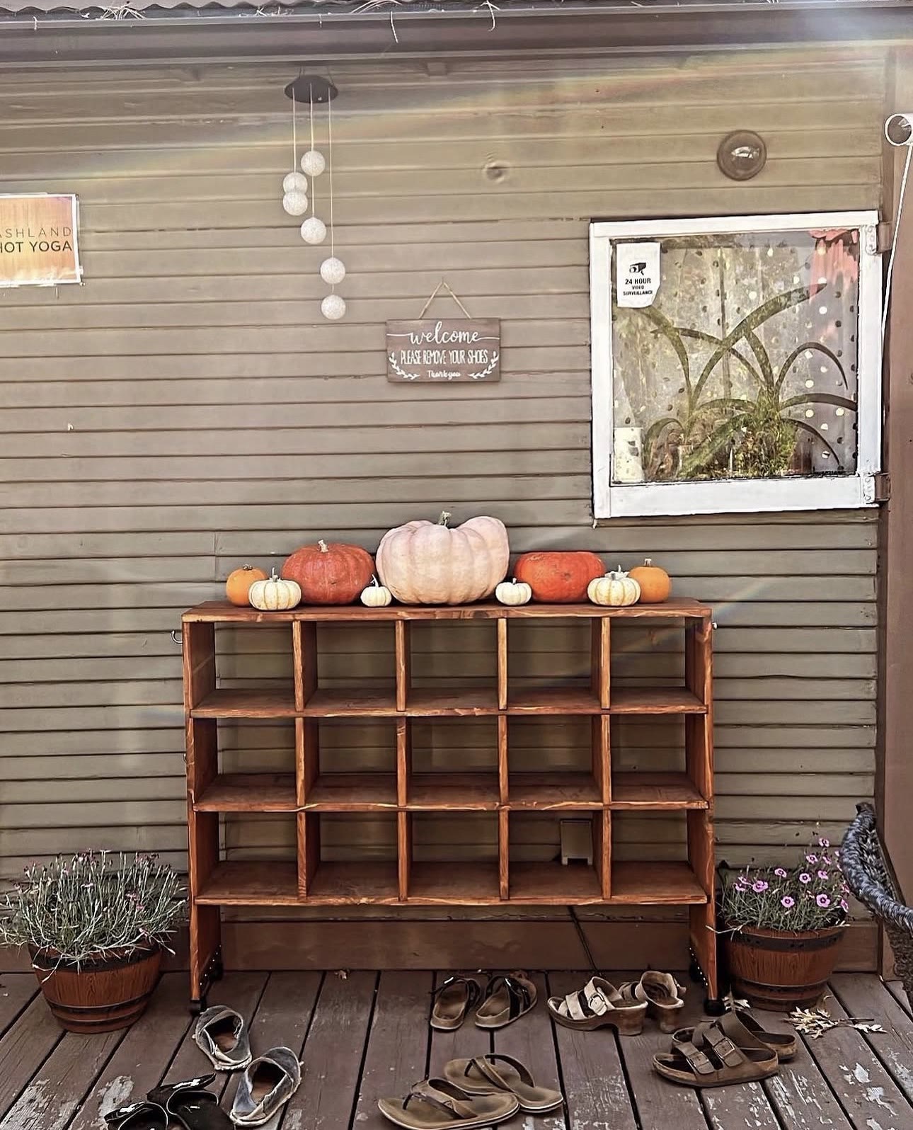 Shoe cubbies and pumpkins at the studio entrance in autumn