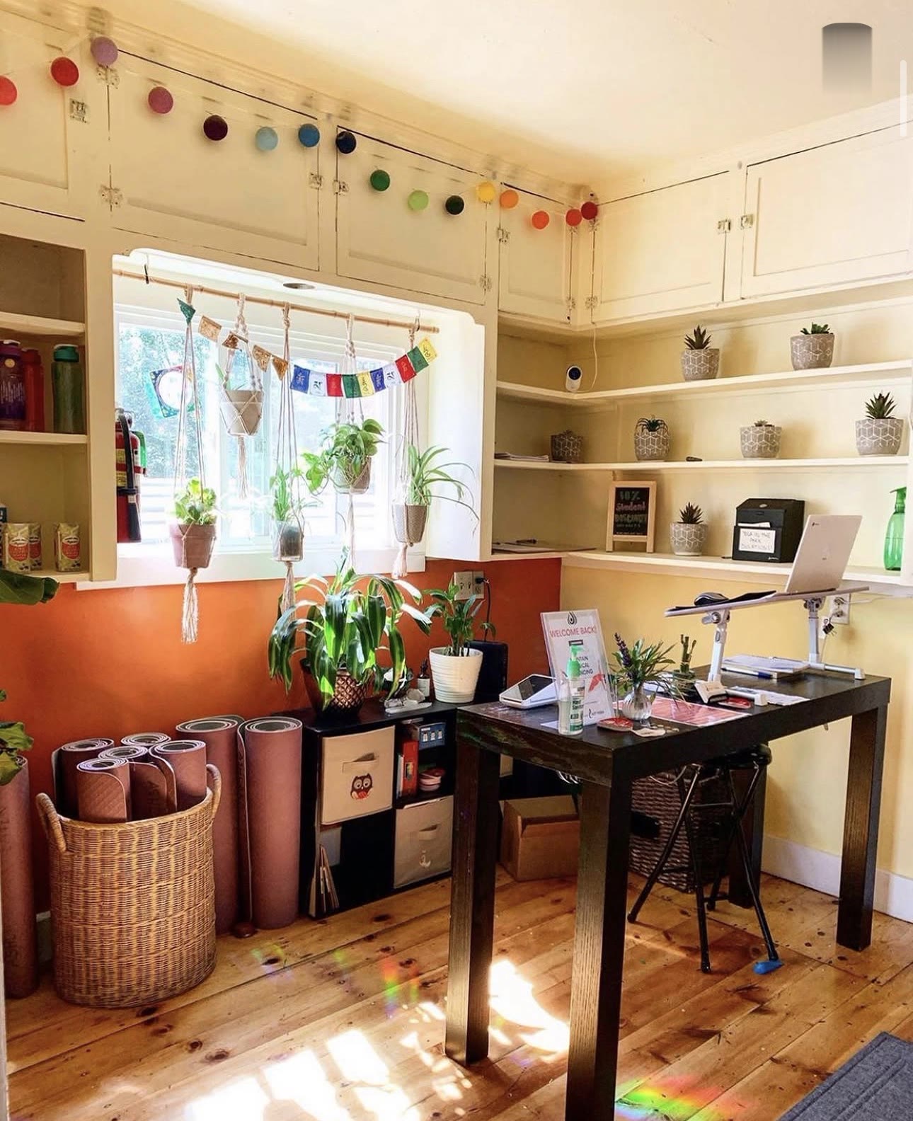 The front desk with rainbow garland and rental mats