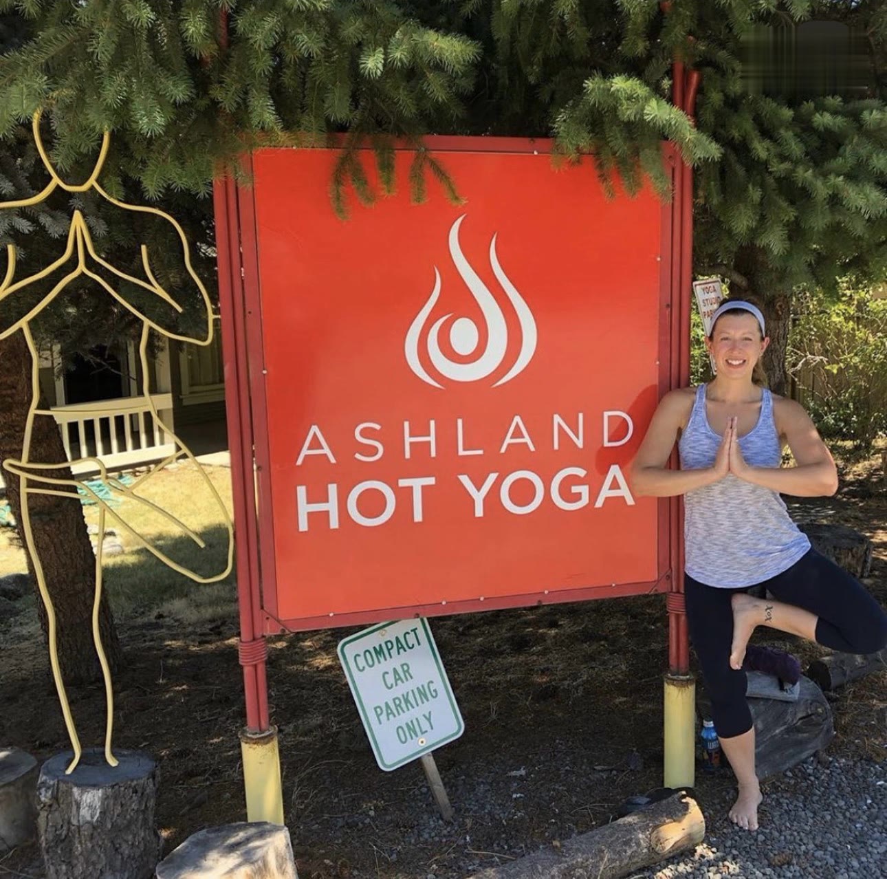Tree pose beside the original red sign